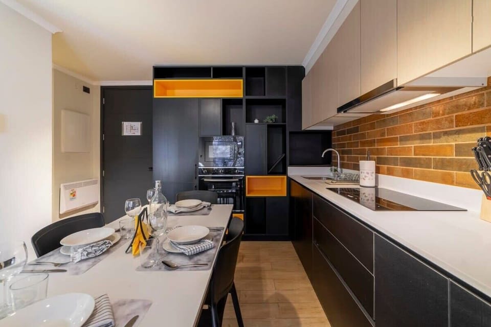 Stylish kitchen with vibrant accents and a cozy dining area, perfect for intimate meals in your Chilean getaway.