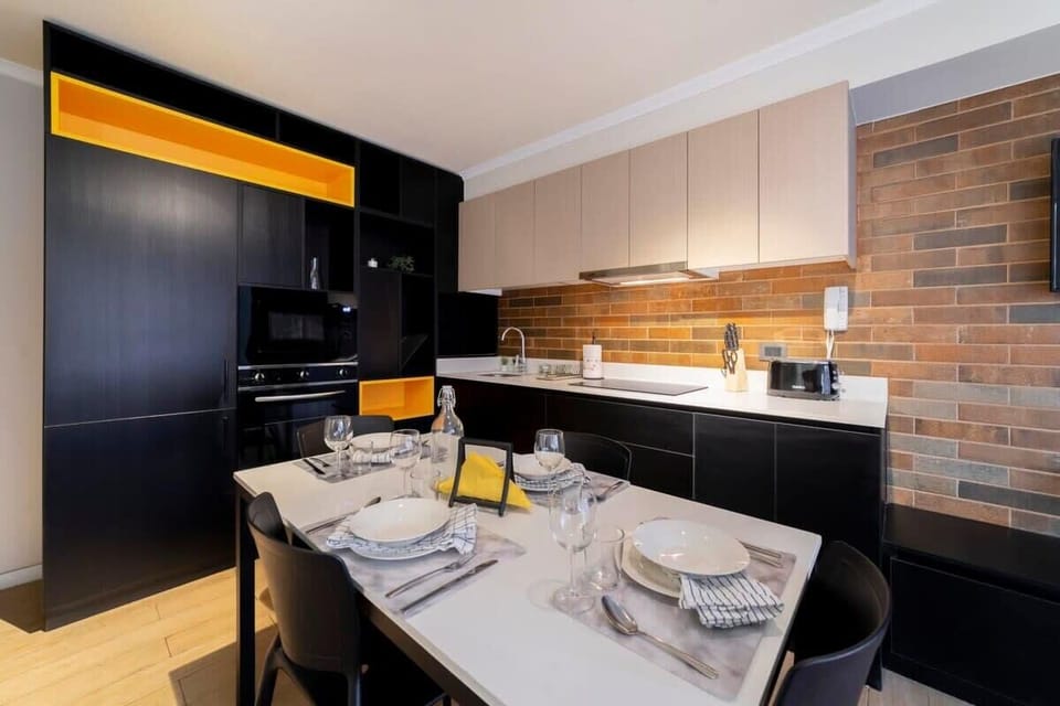 Sleek and modern kitchen with stylish dining area, perfect for cozy meals.