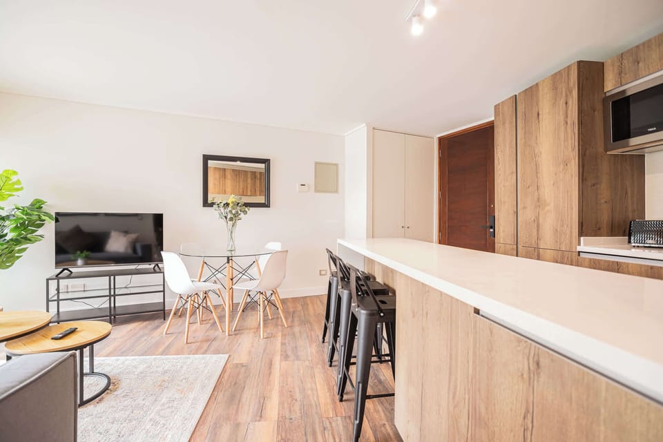 Bright and modern open-plan living space with stylish dining area and kitchen, perfect for relaxing and entertaining.