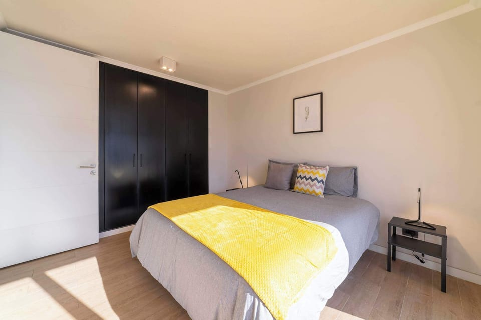 Cozy and bright bedroom with stylish decor and ample storage, perfect for a relaxing stay.