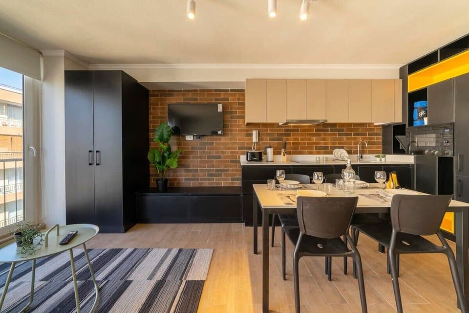 Experience modern living in this stylish studio with a fully-equipped kitchen and cozy dining area, perfect for a comfortable stay.
