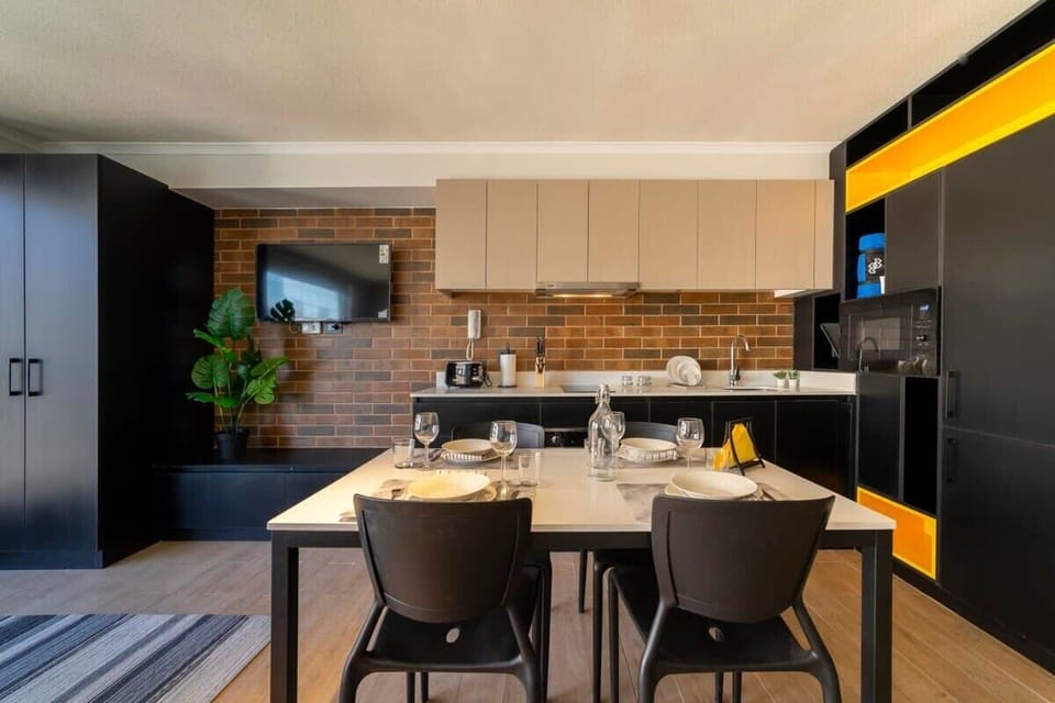Stylish and modern kitchen with dining area, perfect for cozy meals and relaxation.