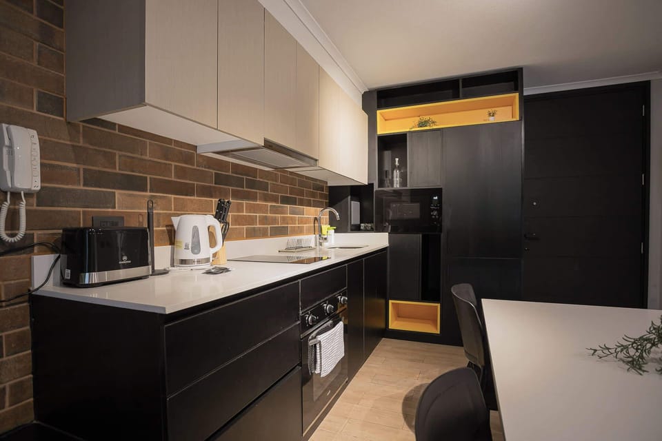 Sleek and modern kitchen with all essentials for a cozy stay in the heart of the city.