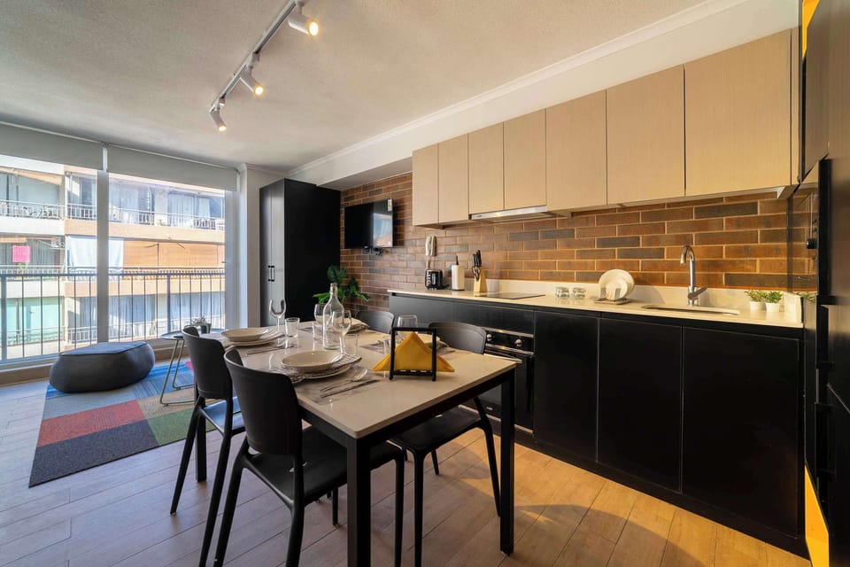 Stylish kitchen with modern amenities and a cozy dining area, perfect for enjoying meals with a view.
