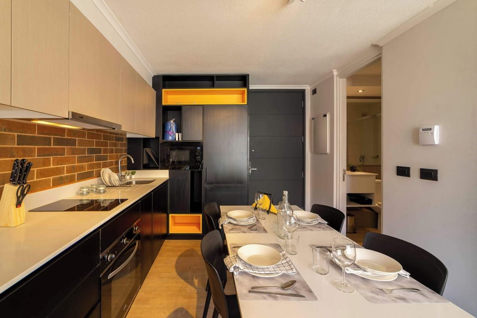 Stylish kitchen with modern amenities and a cozy dining area, perfect for intimate meals.