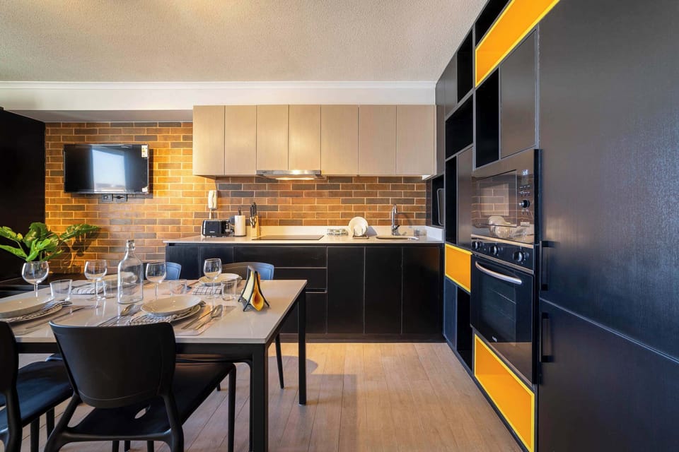 Sleek and modern kitchen with stylish dining area, perfect for cozy meals and relaxation.