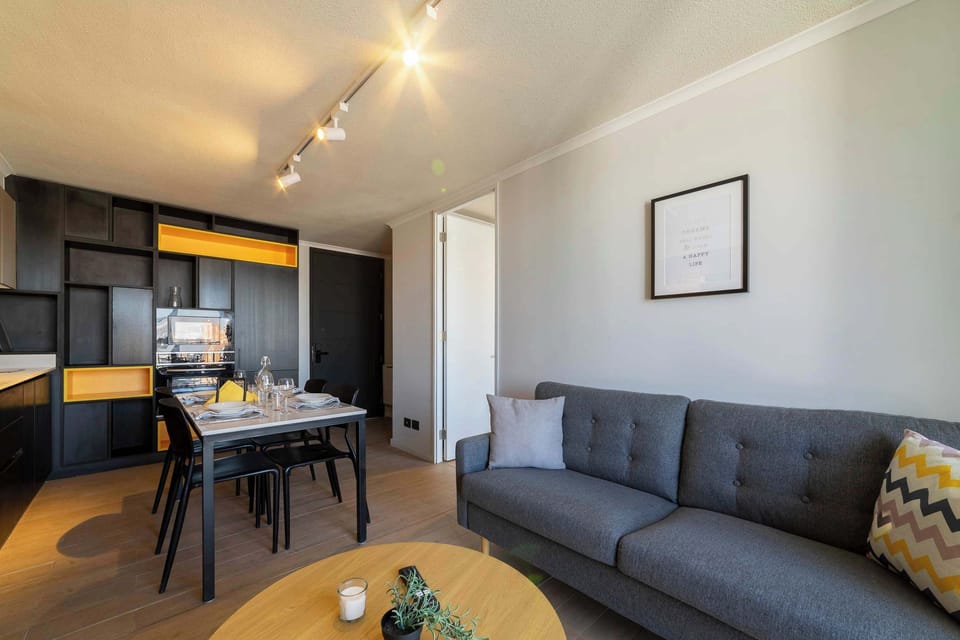 Cozy and modern living space with stylish kitchen and dining area, perfect for a relaxing stay.