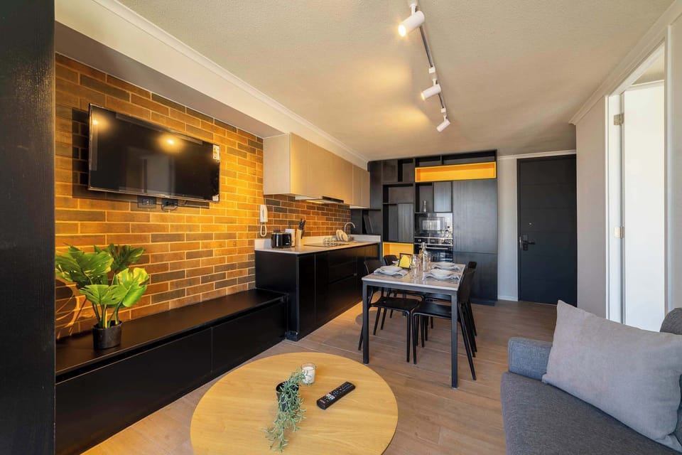Cozy and modern living space with a stylish kitchen and dining area, perfect for a relaxing stay.