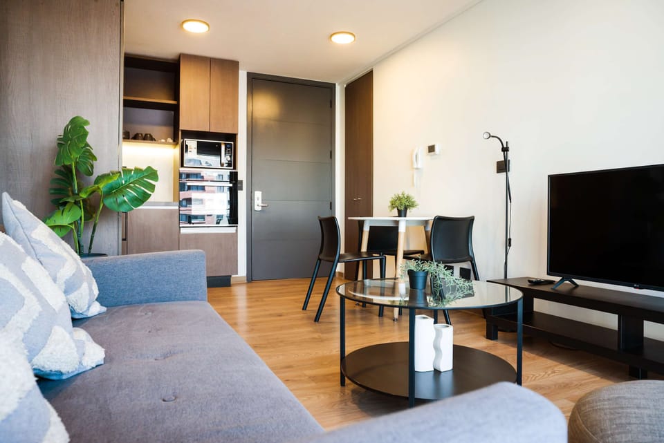 Cozy modern living area with stylish decor and ample natural light, perfect for relaxation and entertainment.