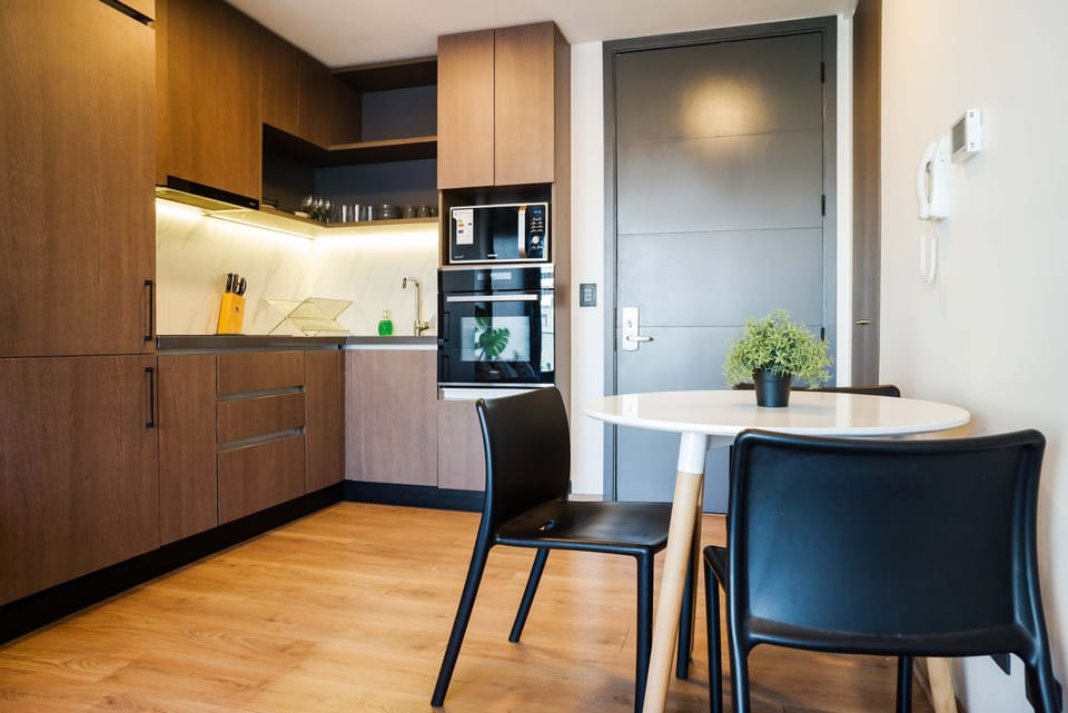 Sleek and modern kitchen with dining area, perfect for cozy meals and culinary adventures.
