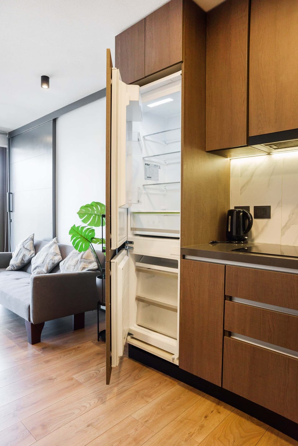 Sleek kitchen with modern amenities and cozy living area, perfect for a comfortable stay.
