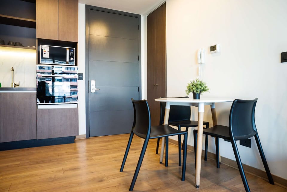 Cozy dining nook with modern kitchenette, perfect for intimate meals in your private apartment.