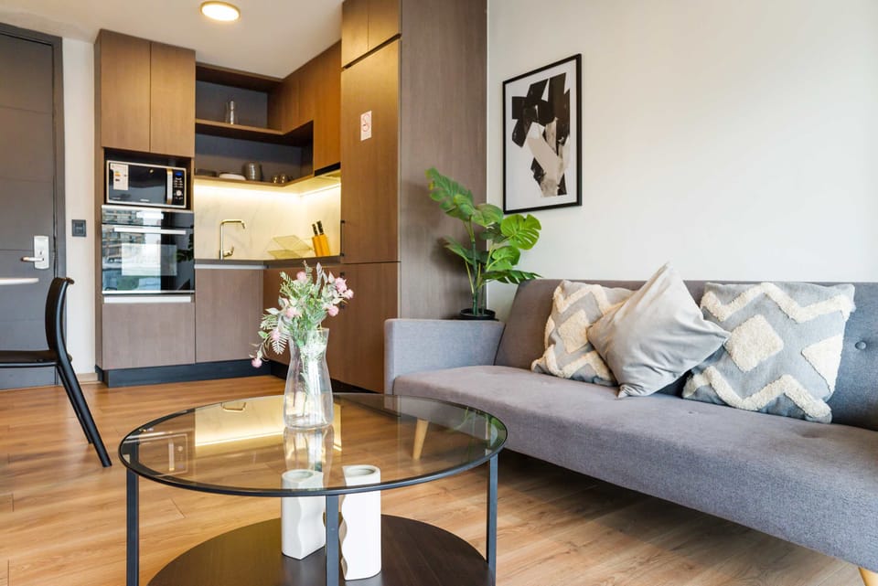 Cozy living space with modern kitchen and stylish decor, perfect for relaxation and cooking.