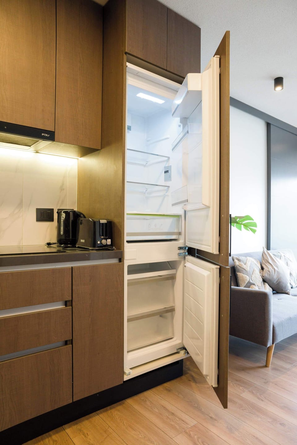 Modern kitchen with sleek appliances and cozy seating area, perfect for relaxing after a day exploring the city.