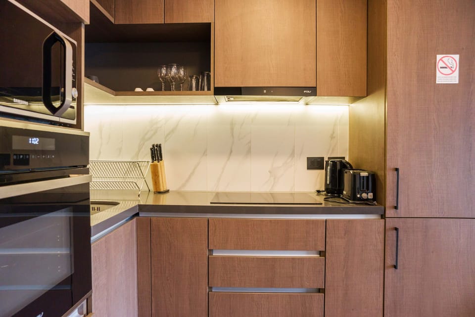 Sleek and modern kitchen with top-notch appliances and stylish finishes, perfect for culinary enthusiasts.