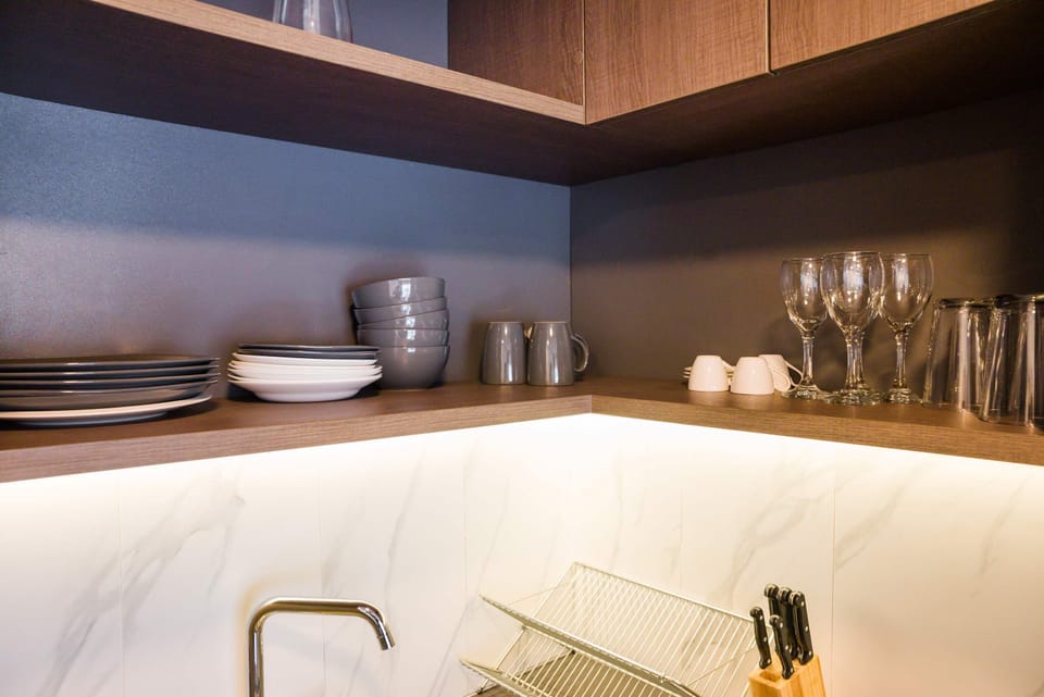 Modern kitchen corner with elegant dishware and sleek design, perfect for cozy meals.