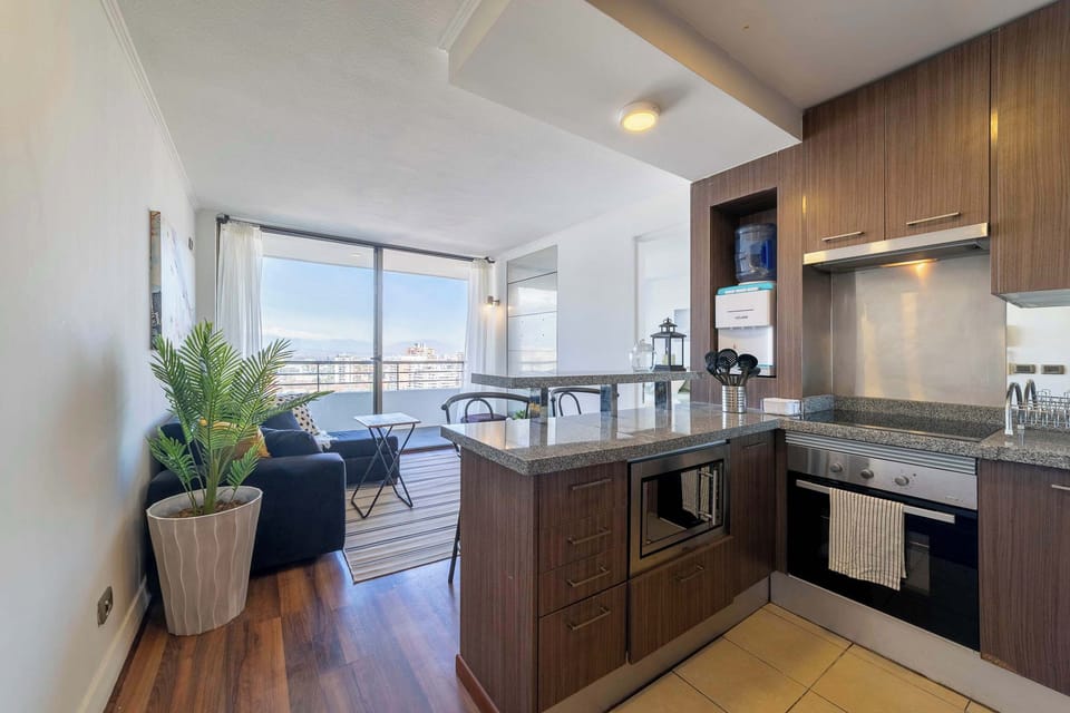 Enjoy cooking in a modern kitchen with stunning city views from the comfort of your cozy apartment.