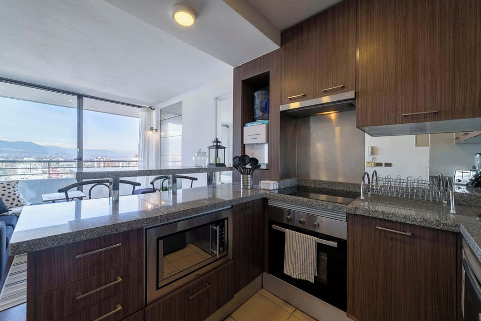 Enjoy cooking with a stunning city view in this modern, fully-equipped kitchen.