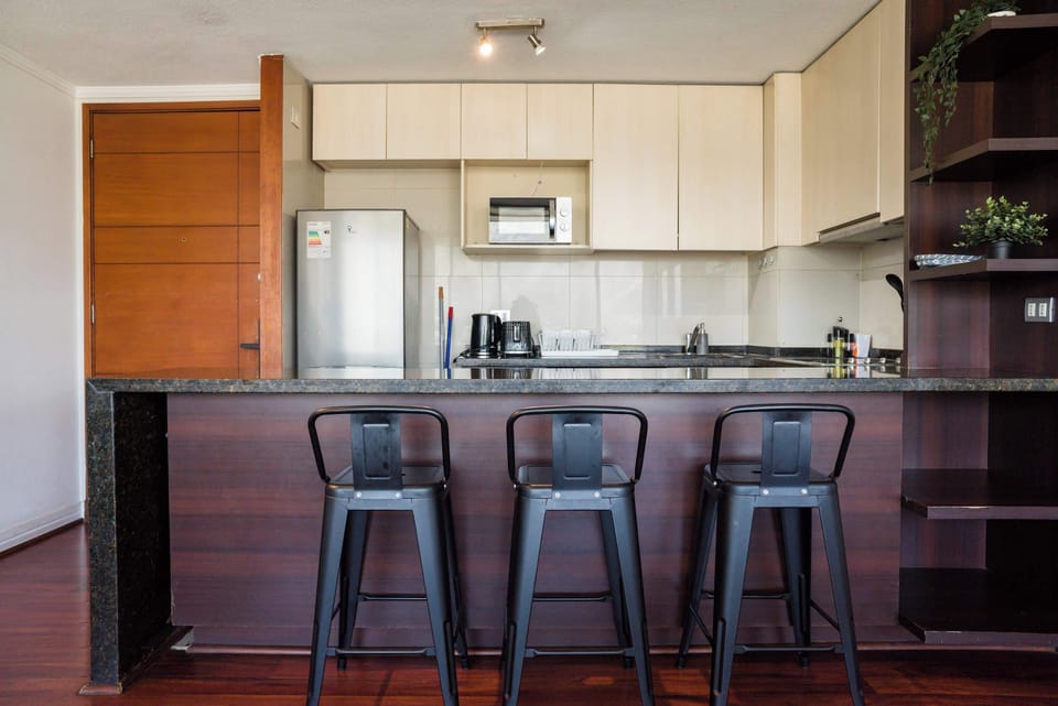 Sleek and modern kitchen with bar seating, perfect for casual meals and entertaining.