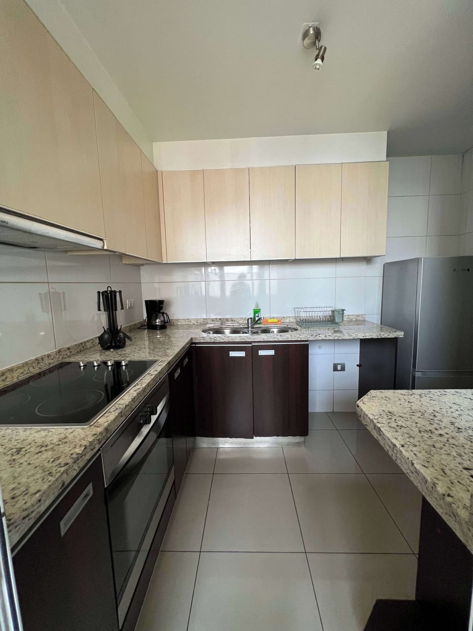 Modern kitchen with sleek appliances and granite countertops, perfect for home-cooked meals.