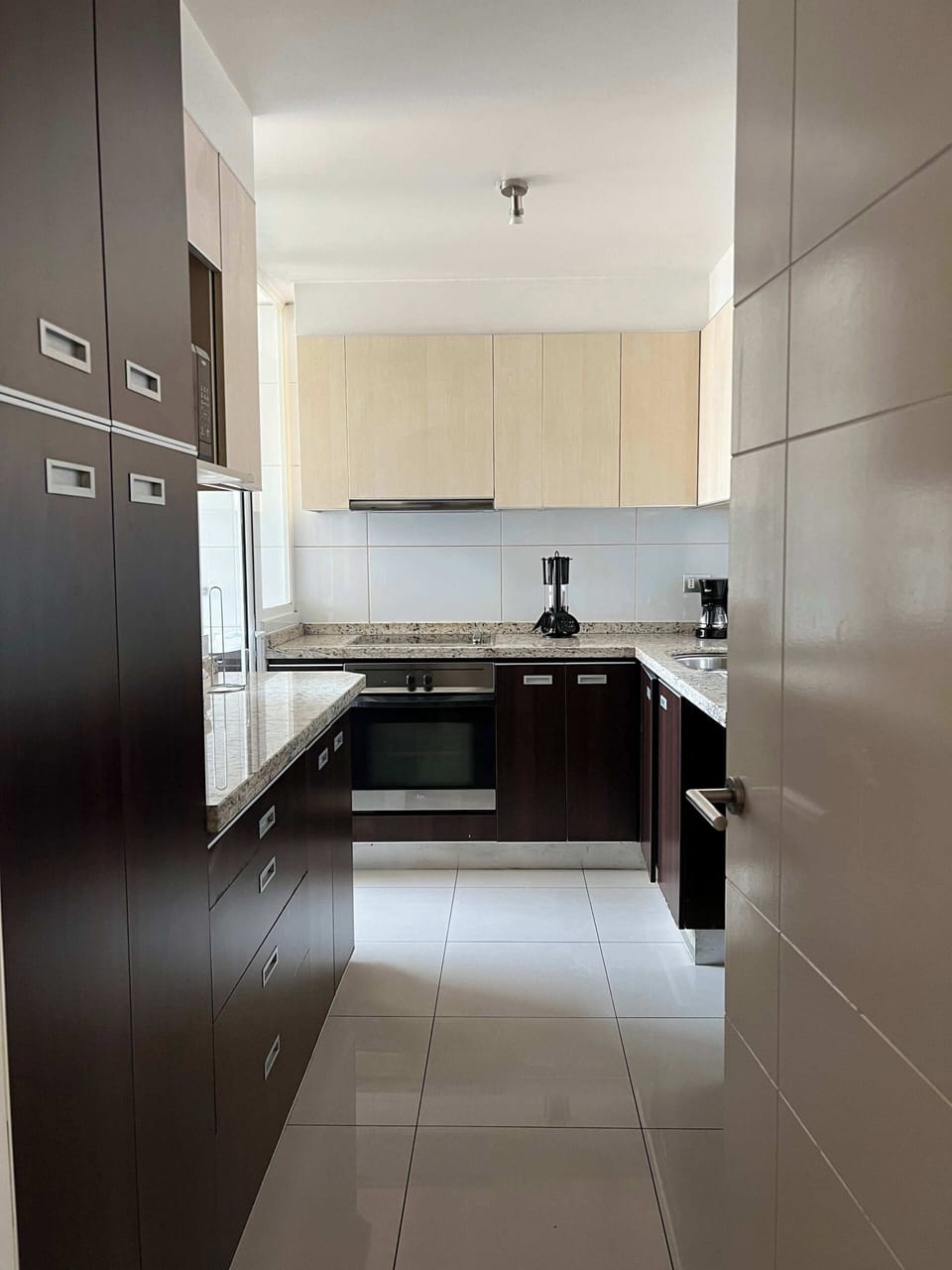 Sleek and modern kitchen with granite countertops and stainless steel appliances, perfect for culinary enthusiasts.