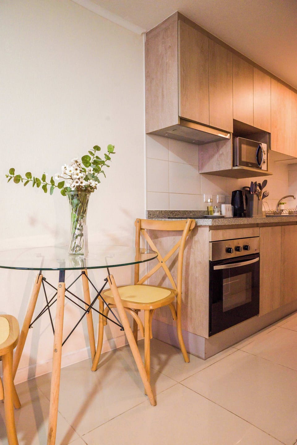Cozy kitchen with modern amenities and a charming dining area, perfect for intimate meals.