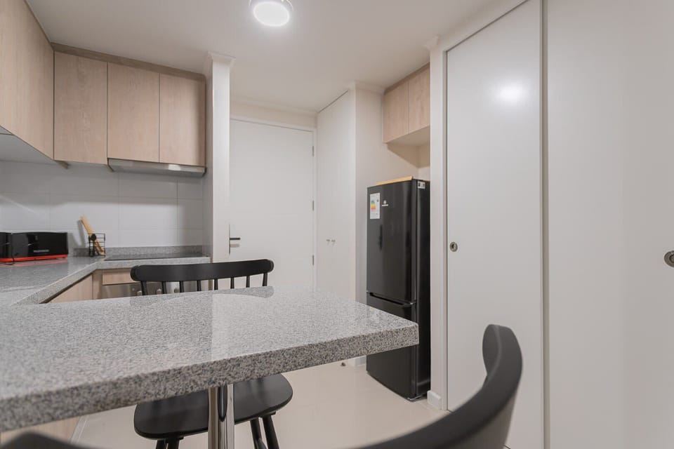 Sleek and modern kitchen equipped for all your culinary needs, perfect for cozy meals in.