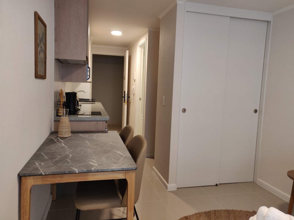 Cozy kitchenette with modern amenities, perfect for a comfortable stay in the heart of the city.