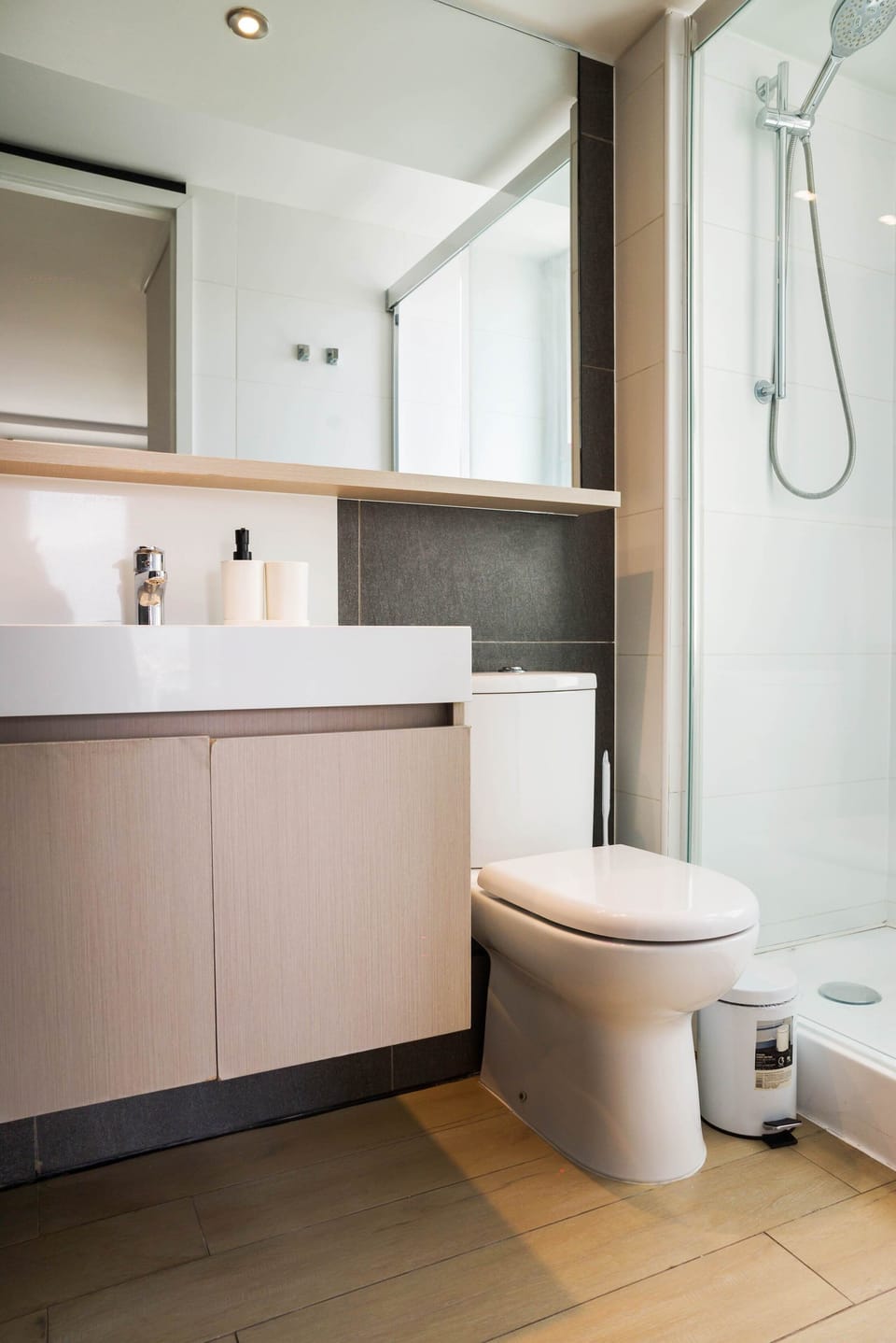 Modern bathroom with sleek fixtures and a spacious shower, perfect for a refreshing start to your day.