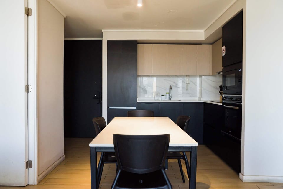 Sleek and modern kitchen with dining space, perfect for enjoying meals in style.