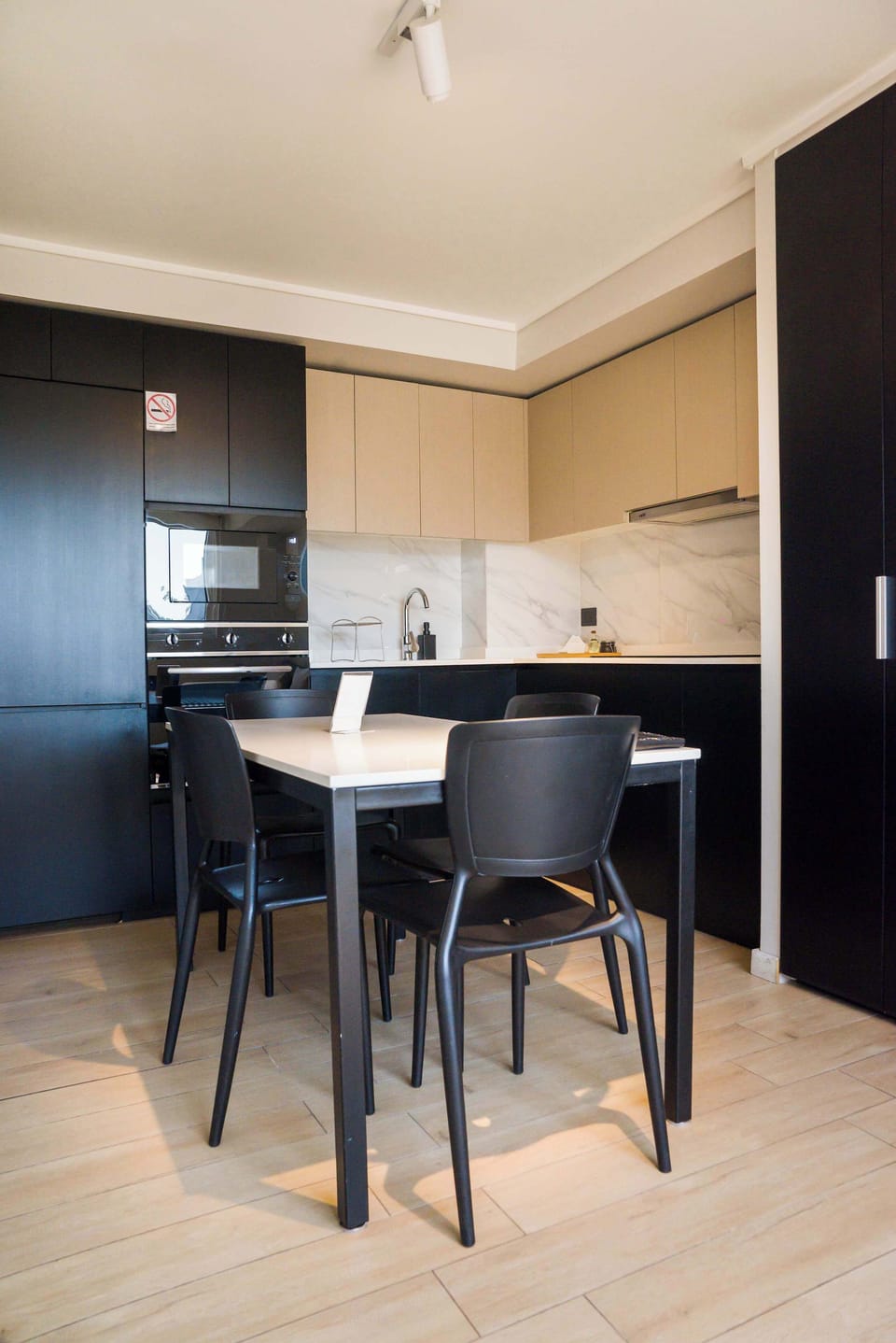 Sleek and modern kitchen with dining area, perfect for cozy meals in your private studio retreat.