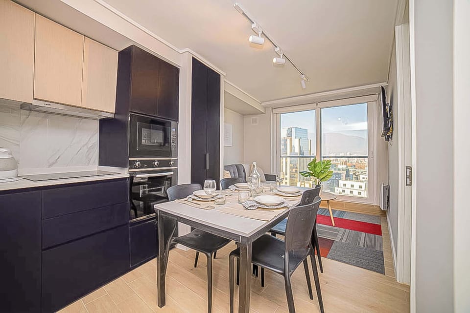 Enjoy city views from this stylish kitchen and dining area, perfect for cozy meals in a modern setting.