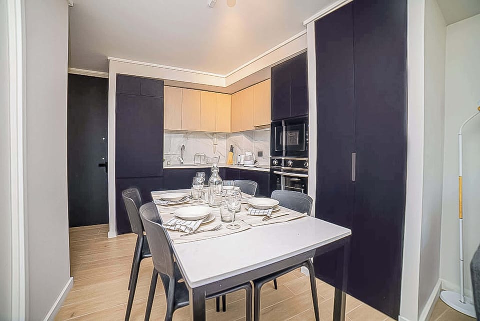 Sleek and modern kitchen with dining area, perfect for cozy meals in a stylish setting.