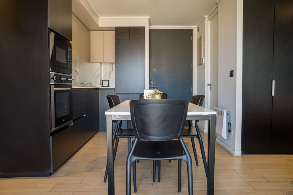 Sleek and modern kitchen with dining area, perfect for cozy meals and culinary adventures.
