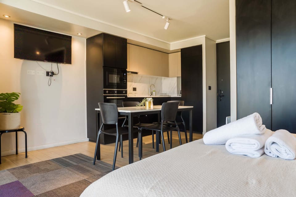 Cozy studio with a sleek kitchen and dining area, perfect for a comfortable stay in the heart of Chile.