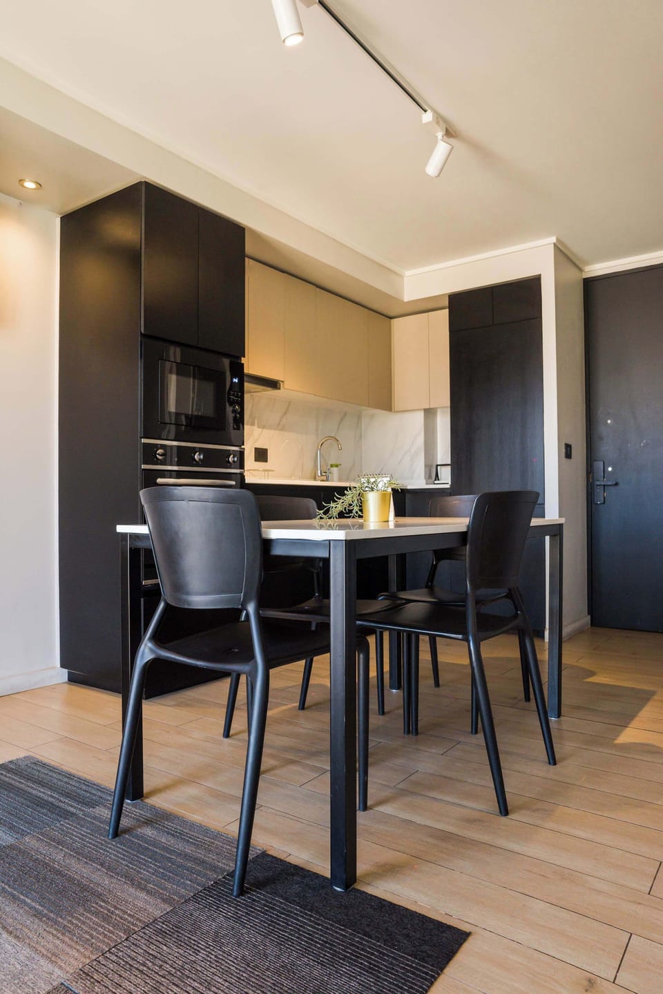 Modern kitchen with sleek design and dining area, perfect for cozy meals in a stylish setting.