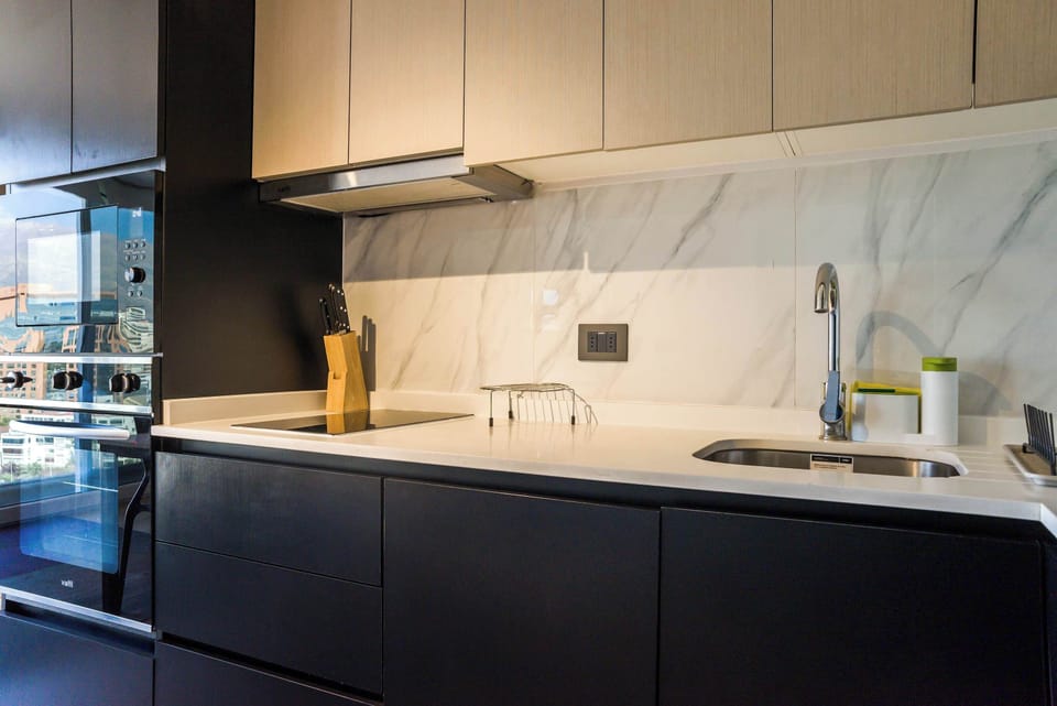 Sleek and modern kitchen with high-end appliances and elegant marble accents, perfect for culinary enthusiasts.