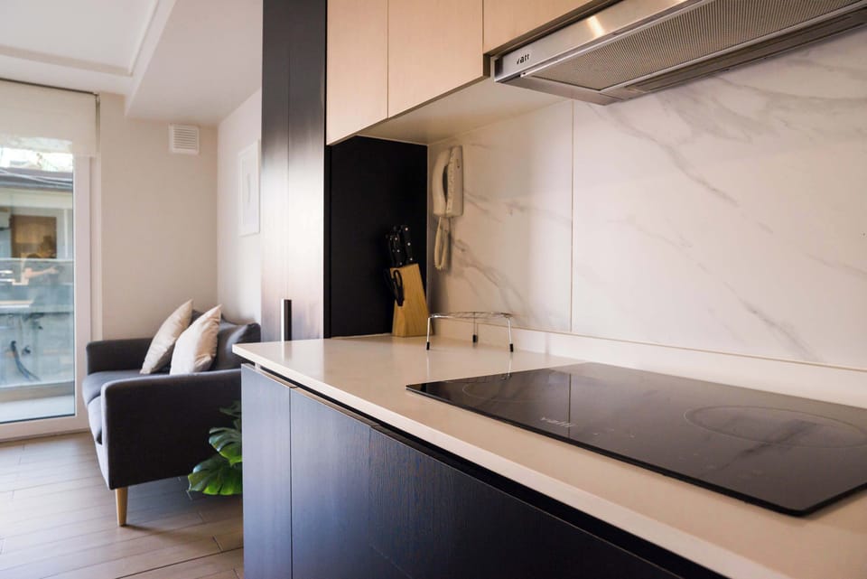Sleek kitchen with modern amenities and a cozy seating area, perfect for relaxing after a day in the city.