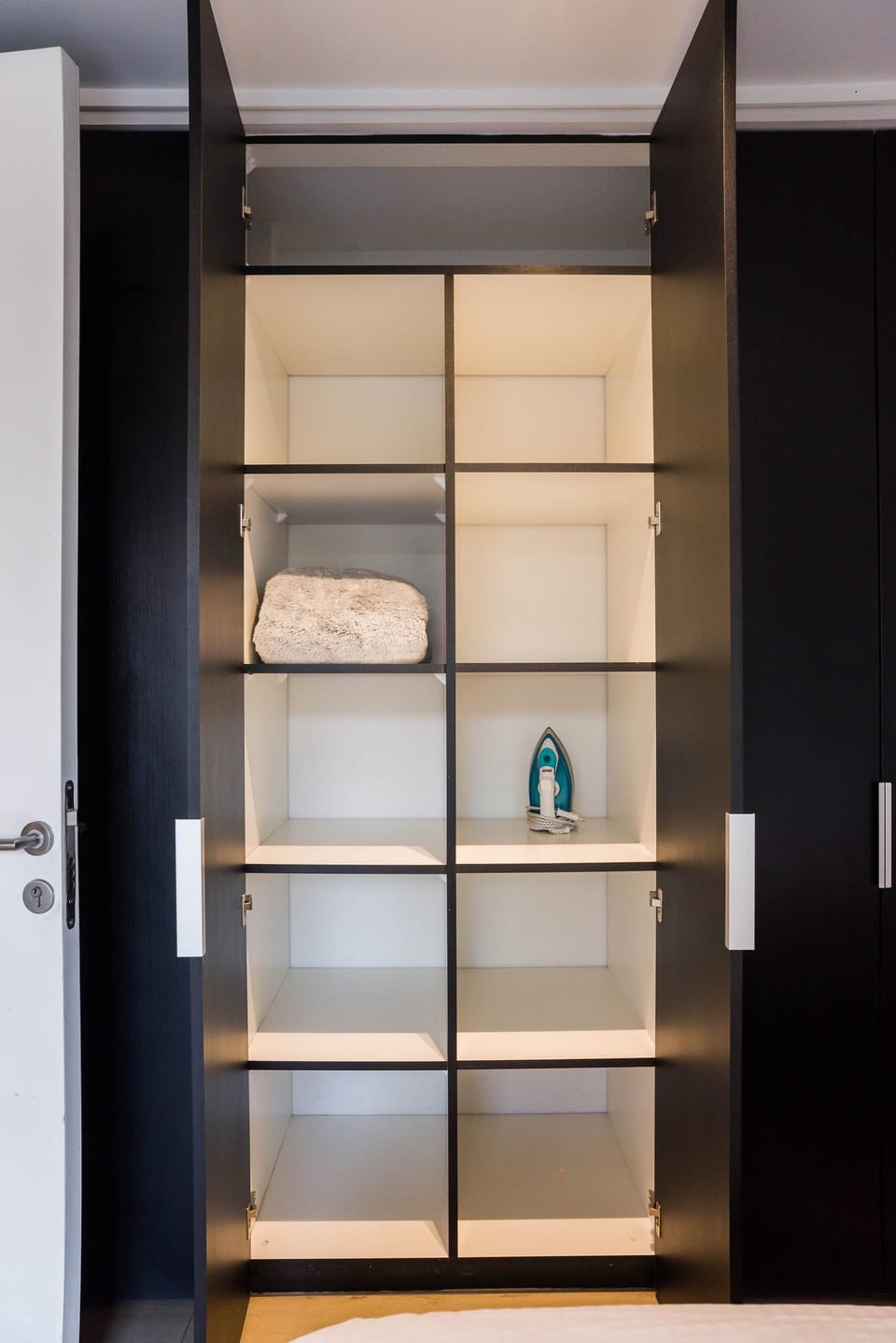 Organized wardrobe with ample storage and essentials for a comfortable stay.