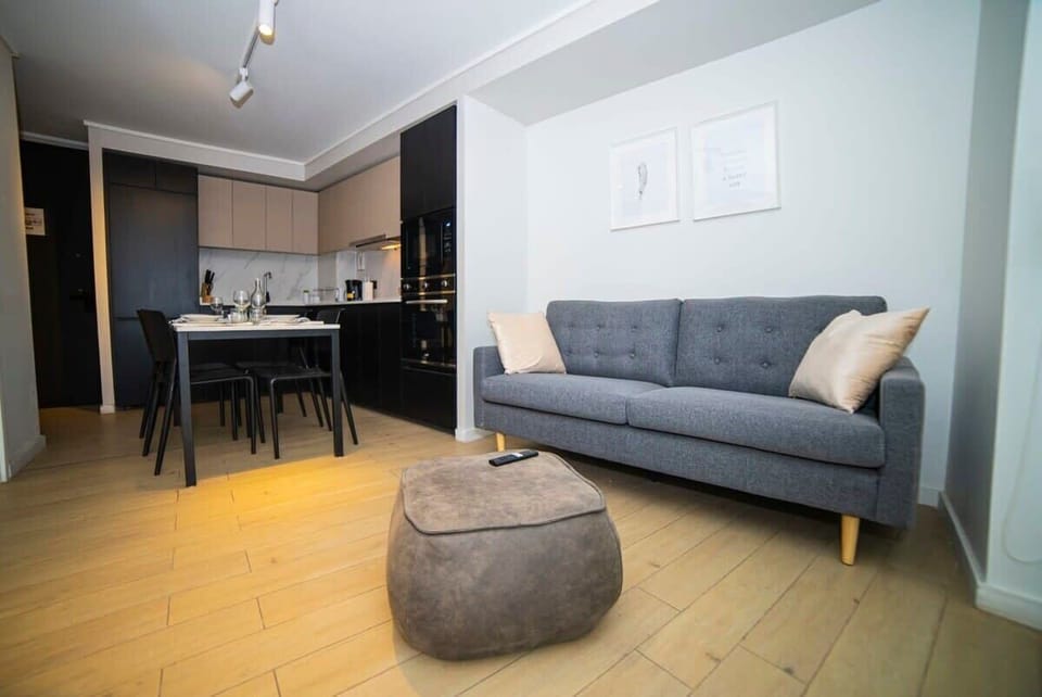 Cozy and modern living space with a sleek kitchen and comfortable seating, perfect for a relaxing stay.