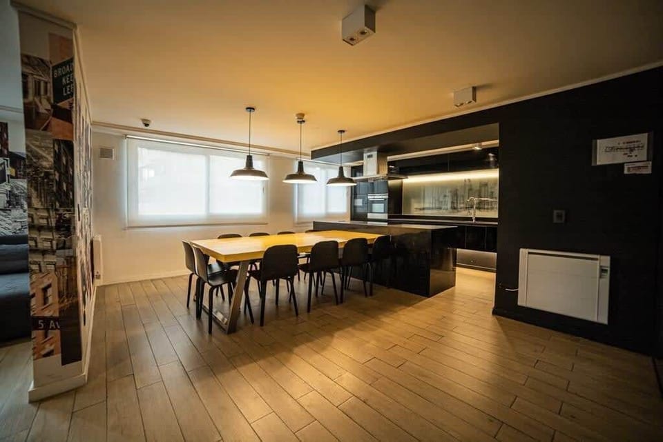 Enjoy a stylish dining experience in this modern space with a sleek kitchen and ample seating.