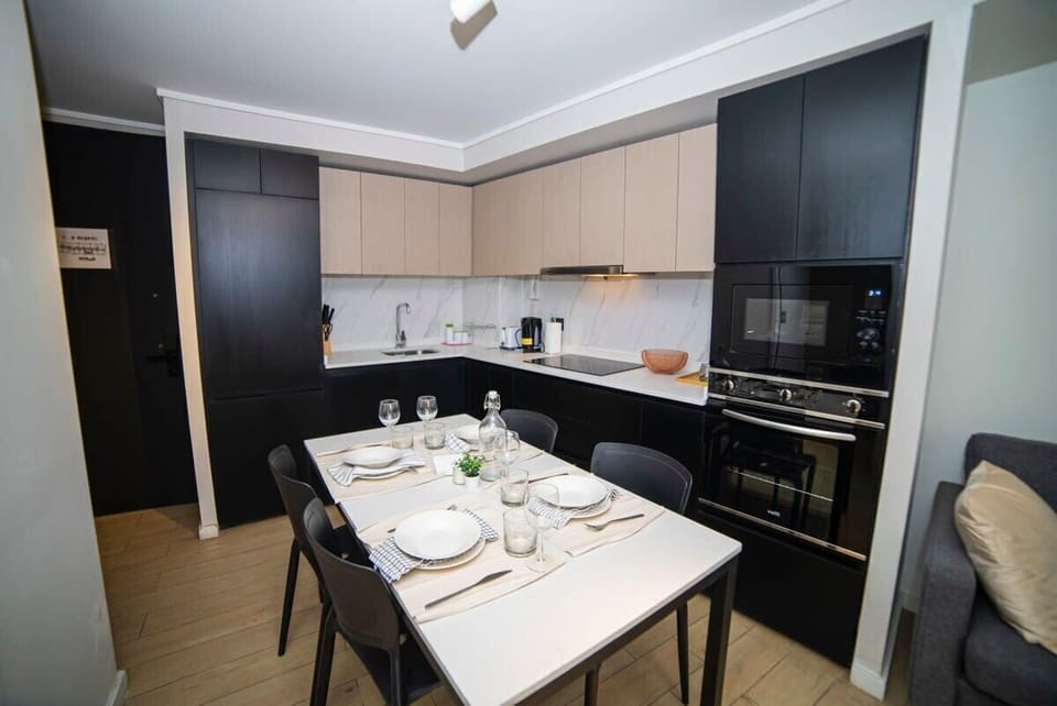 Sleek and modern kitchen with dining area, perfect for cozy meals in your private studio retreat.
