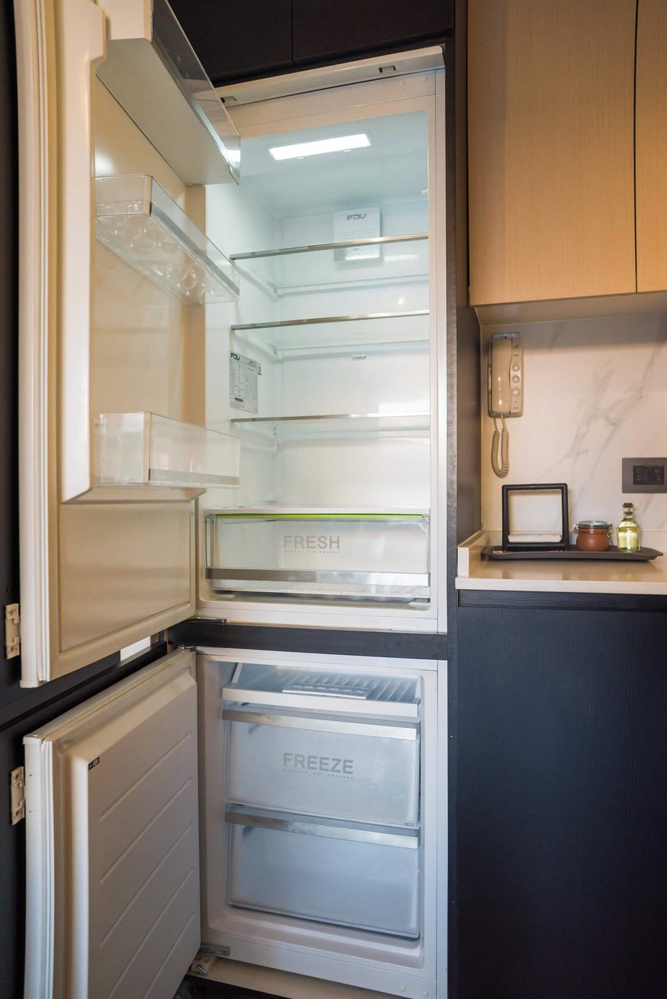 Modern kitchen with a spacious fridge, perfect for storing your culinary creations during your stay.