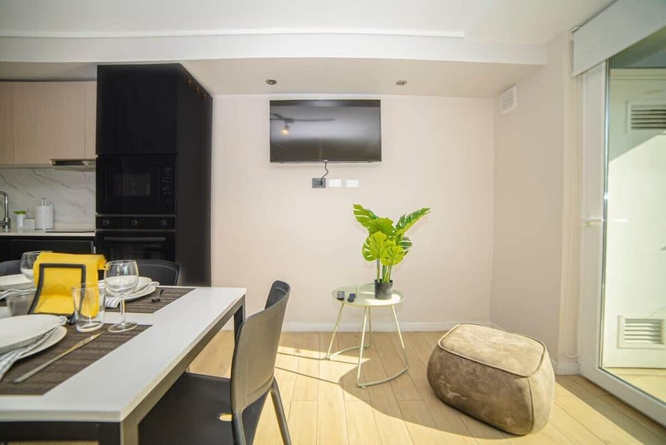 Bright and cozy living space with modern amenities and a dining area, perfect for relaxing after exploring the city.