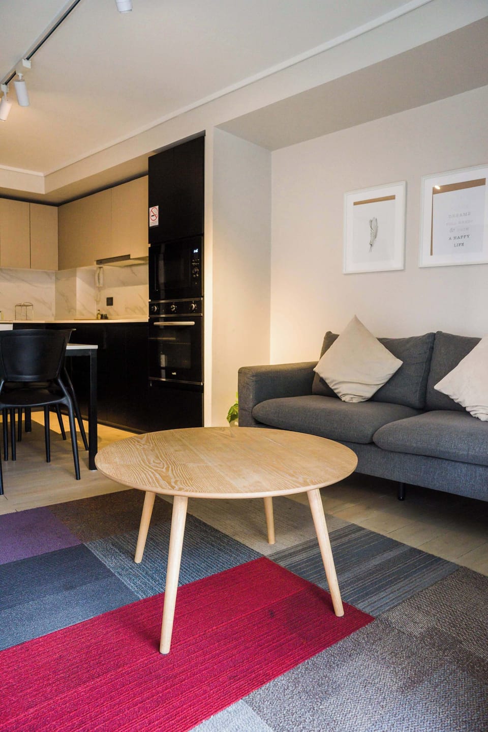Modern studio with a cozy living area and sleek kitchen, ideal for a city getaway.