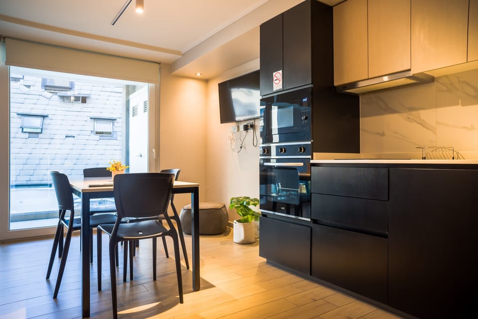Modern kitchen and dining area with sleek design, perfect for cozy meals with a view.