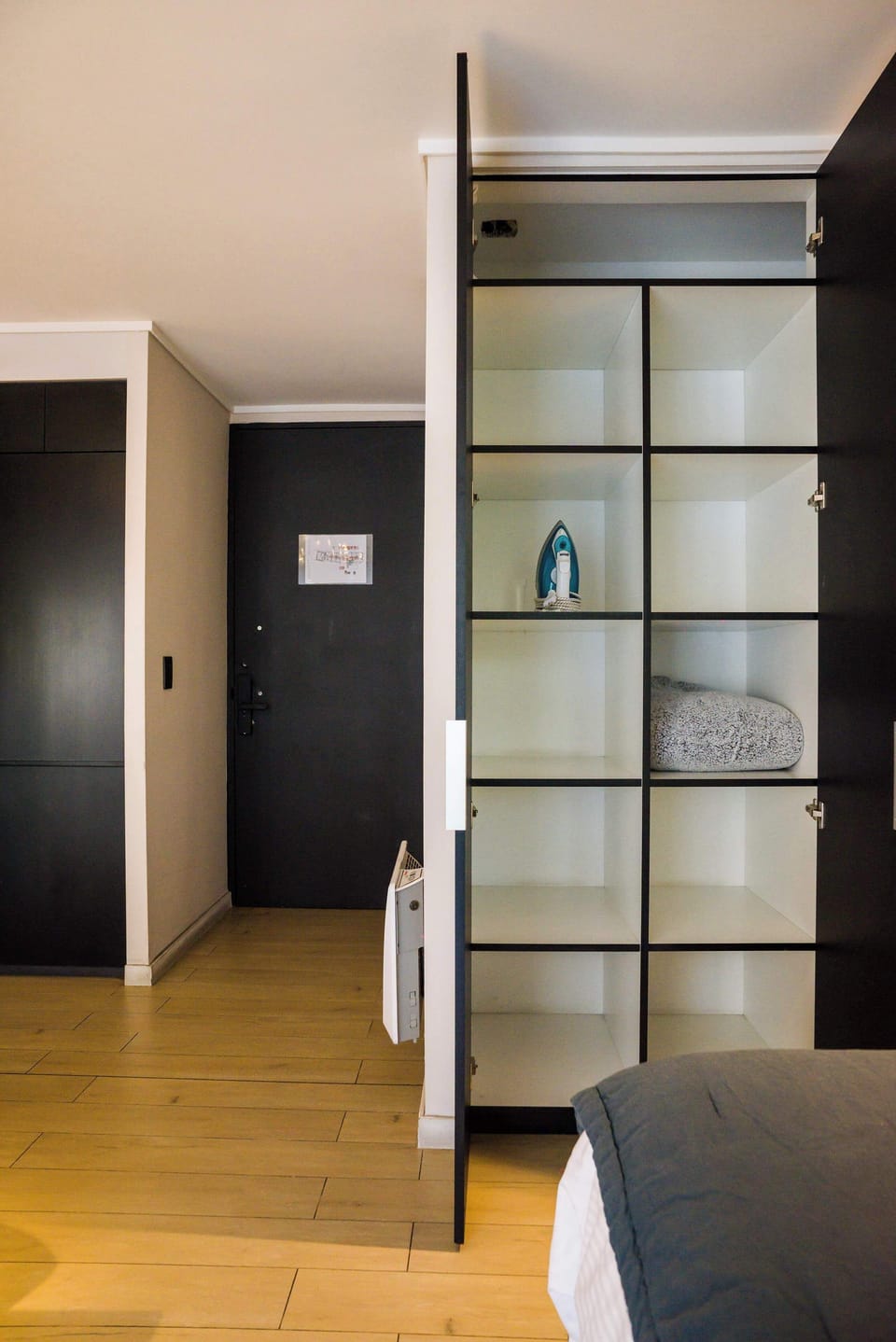 Sleek storage solutions enhance functionality in this modern studio, perfect for a comfortable stay.