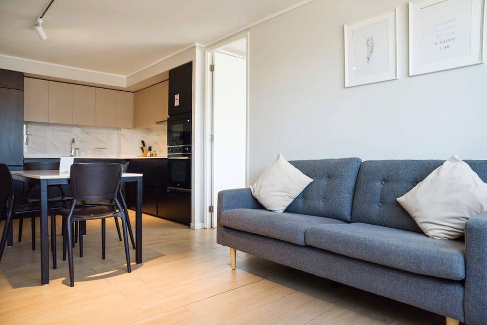 Modern living area with sleek kitchen and cozy seating, ideal for unwinding after city adventures.