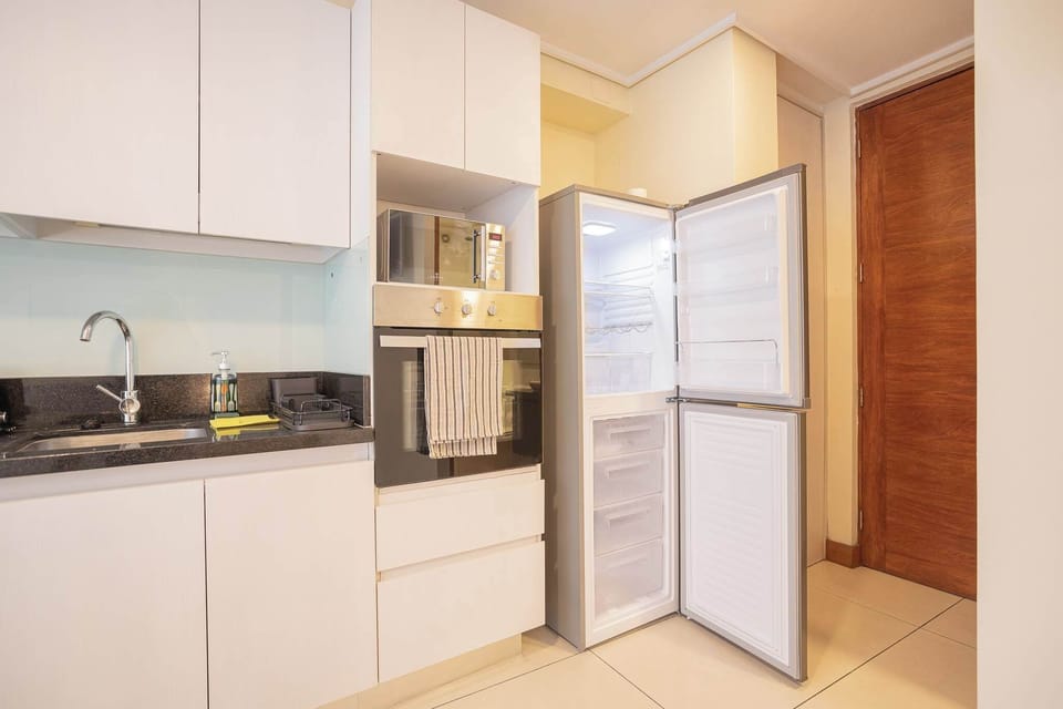 Modern kitchen with sleek appliances and ample storage, perfect for preparing meals during your stay.