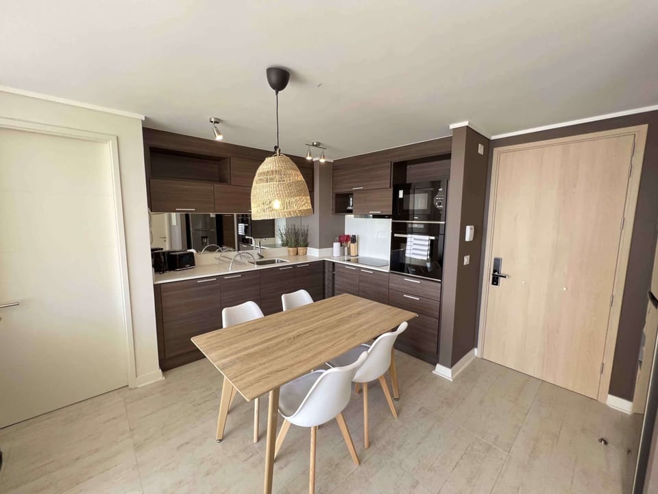 Sleek kitchen with integrated dining area, perfect for cozy meals and gatherings.